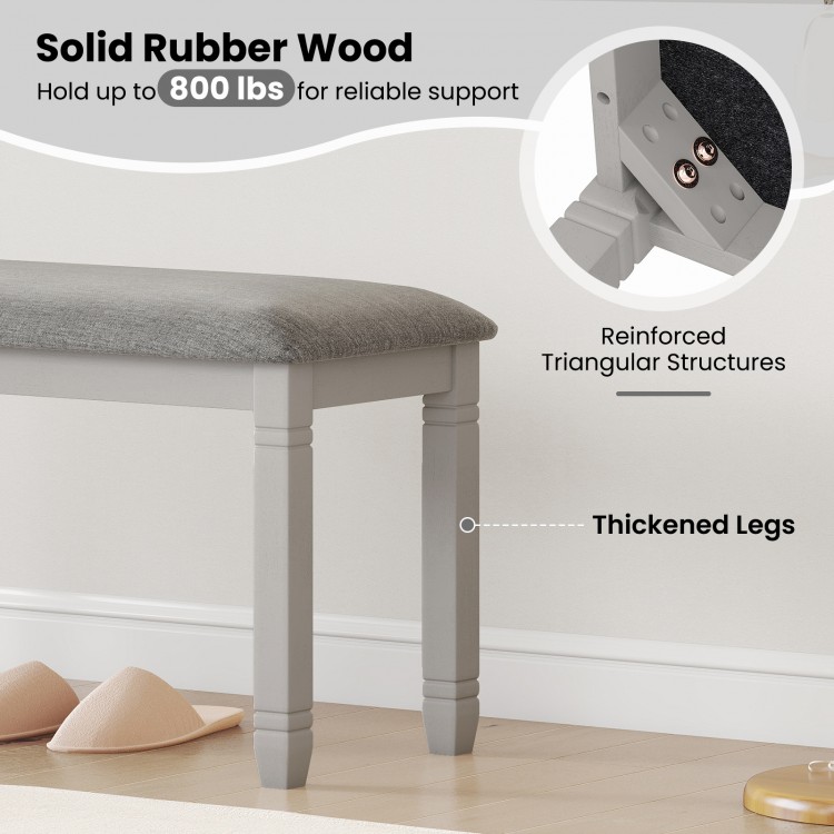 Upholstered bedroom bench with gray padded seat and solid rubber wood legs, supporting up to 800 lbs for versatile use.
