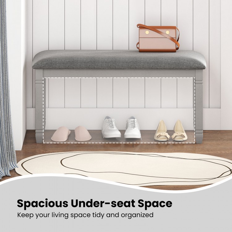 Upholstered gray bedroom bench with padded seat and solid wood legs, featuring spacious under-seat storage for.