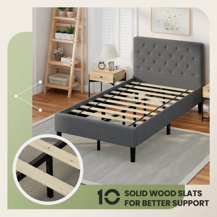 Upholstered bed base with button-stitched headboard and solid wood slats for enhanced support and under-bed storage.