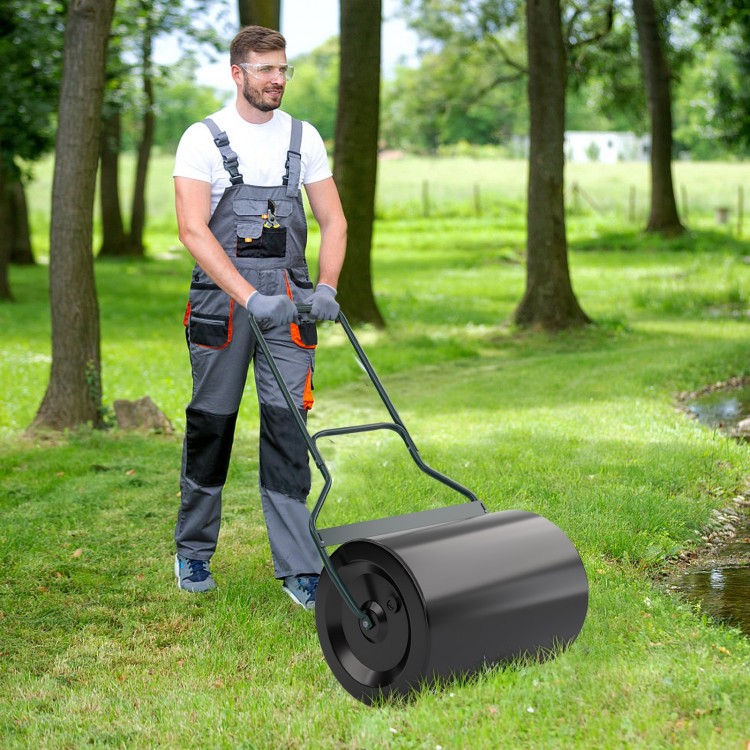 Lawn roller with U-shaped handle in use, featuring a green sprayed surface for stylish and effective lawn flattening.