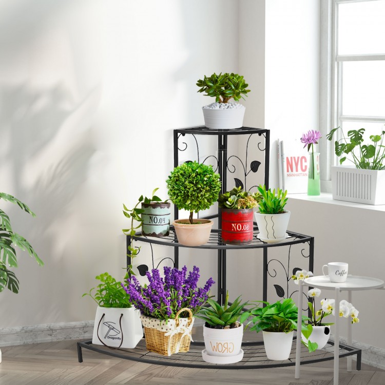 Three-tier floral corner metal plant pot rack in black, showcasing potted plants and decorative items for home or patio.