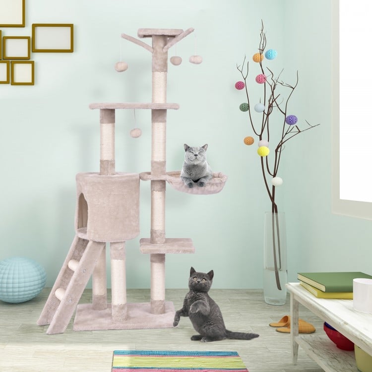 Two playful cats on the 56-inch condo scratching post cat tree, featuring platforms and fluffy balls for climbing and.