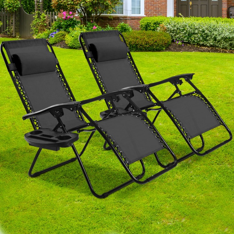 Two black folding lounge chairs with adjustable backs and removable headrests, perfect for outdoor relaxation in the.