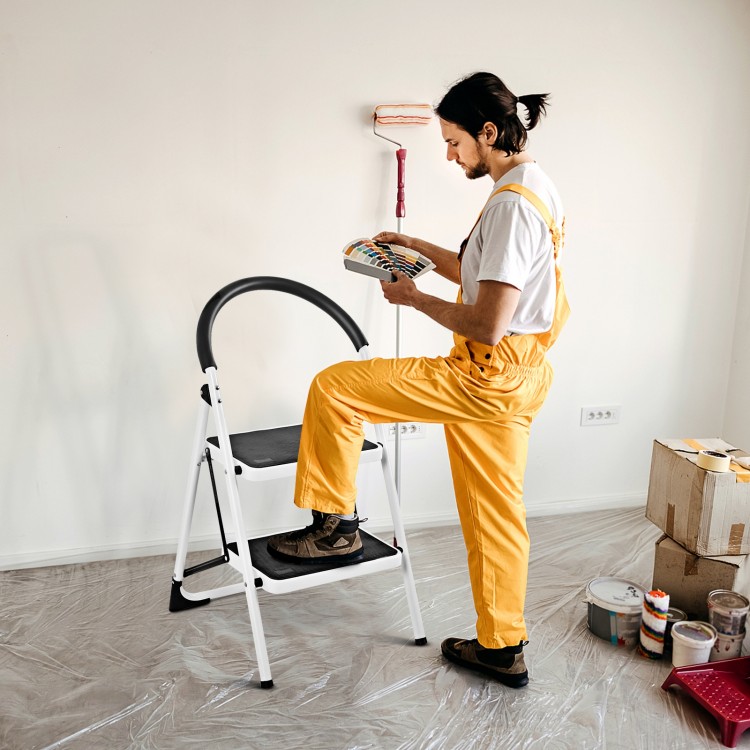 Folding step stool with iron frame and anti-slip pedals, ideal for reaching high places in home or office tasks.