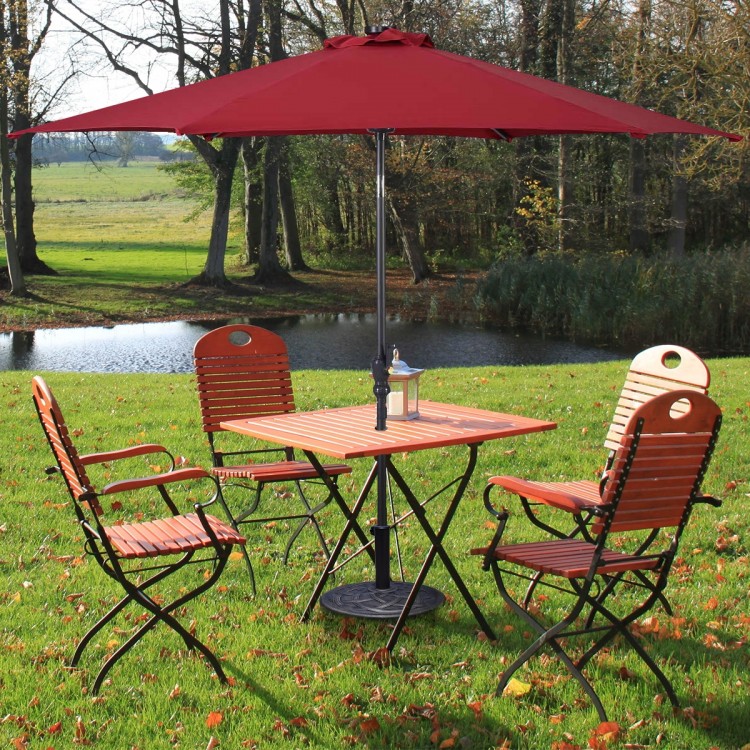 Heavy duty round umbrella base stand with bronze finish, securely holding umbrellas for outdoor use.