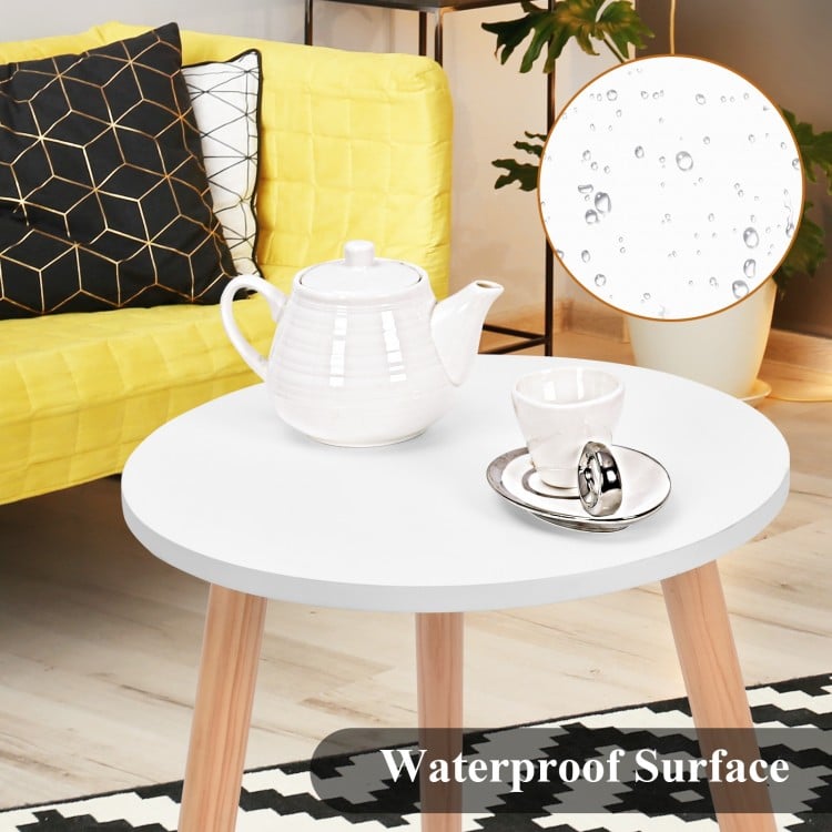 Modern round coffee table with white MDF top and pine wood legs, ideal for living room or kitchen use.