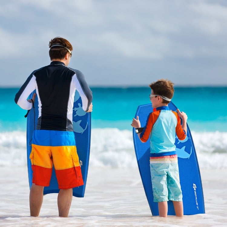 Father and son holding blue Super Bodyboards at the beach, ready for a fun day of surfing in the waves.