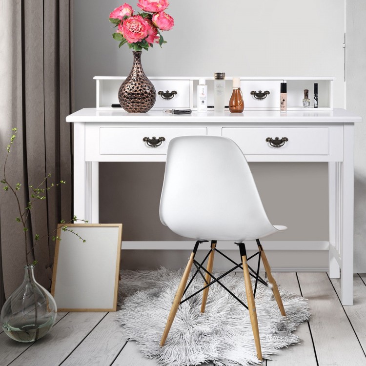 White home office writing desk with four drawers and solid wood legs, styled with a modern chair and decorative items.