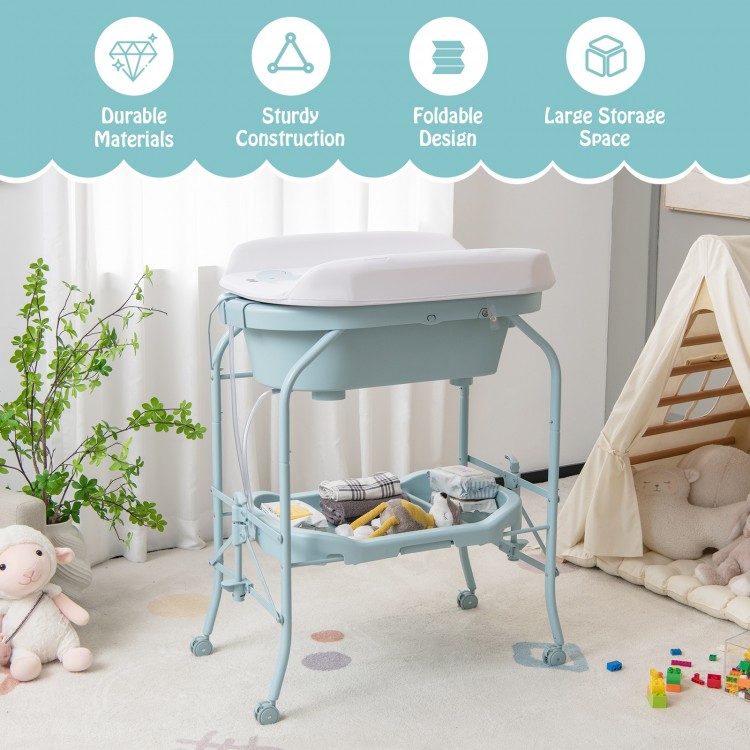 Folding baby changing table with bathtub in blue, featuring sturdy steel frame, storage basket, and 4 universal wheels.
