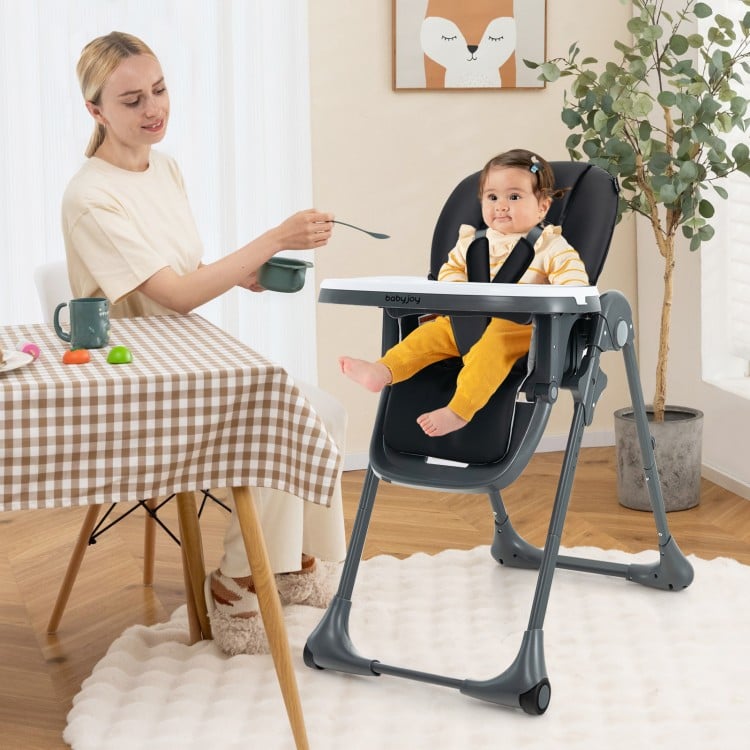 Convertible black baby high chair with adjustable seat height and removable tray, perfect for feeding and playtime.