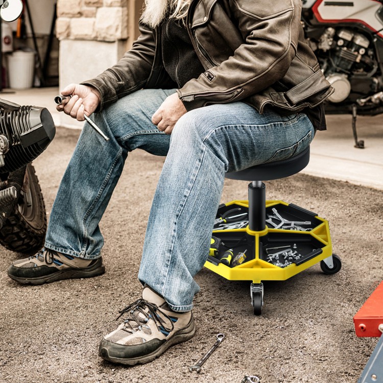 Pneumatic rolling mechanic stool with padded seat, yellow, featuring a tool tray and adjustable height for convenience.