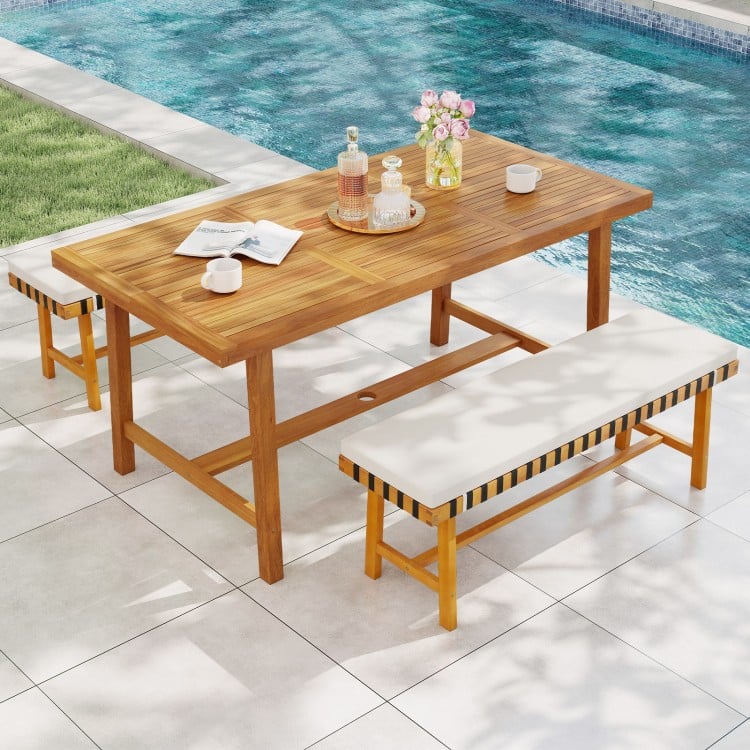 Acacia wood dining table for 6 with smooth surface, umbrella hole, ideal for outdoor dining by the pool.