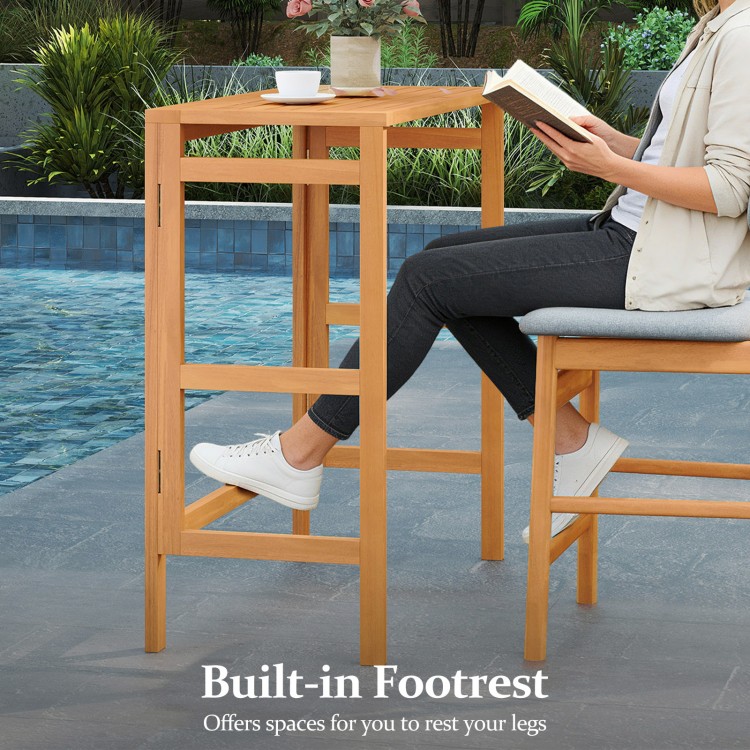 Acacia wood outdoor bar table with slatted tabletop and built-in footrest, perfect for balcony or patio use.