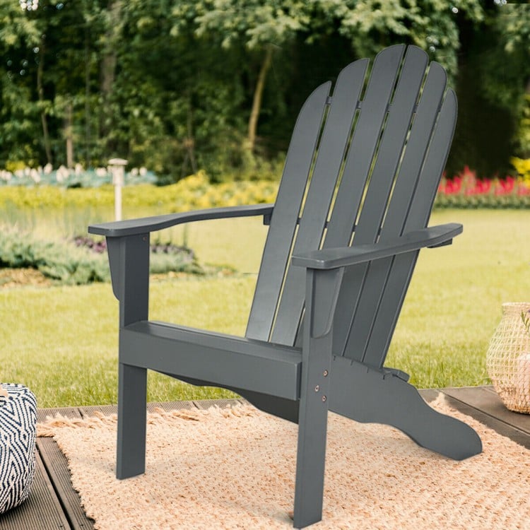 Gray acacia wood Adirondack chair with ergonomic design, perfect for outdoor patio relaxation and durable use.