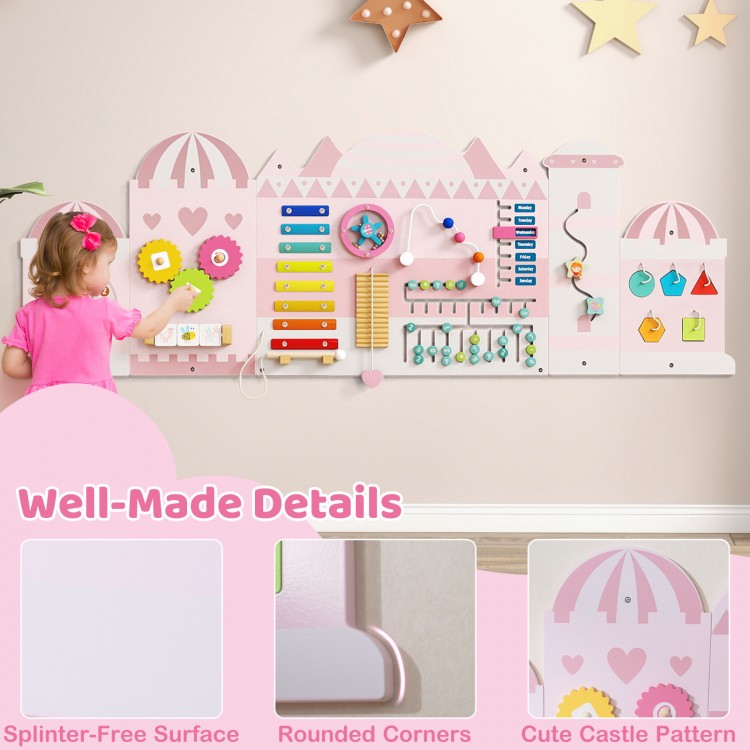 Wooden pink activity wall busy board for toddlers featuring a xylophone, clock, and various sensory activities for.