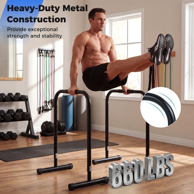 Adjustable dip bar station in black with heavy-duty metal construction, supporting 660 lbs for versatile strength.
