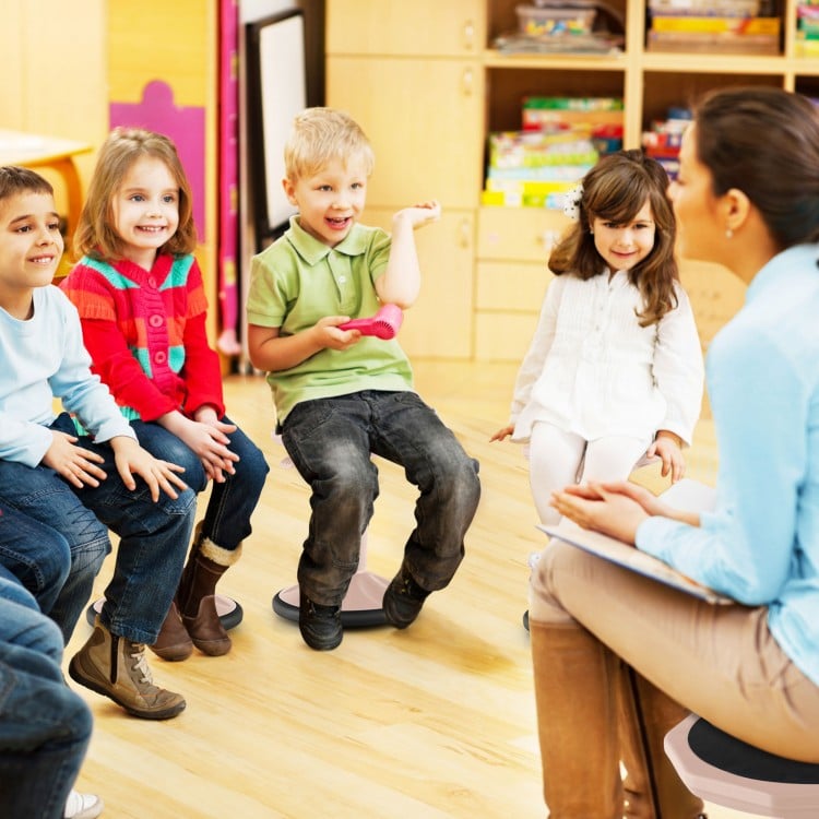 Adjustable-height pink wobble chair for active learning, promoting good posture and core strength in children.