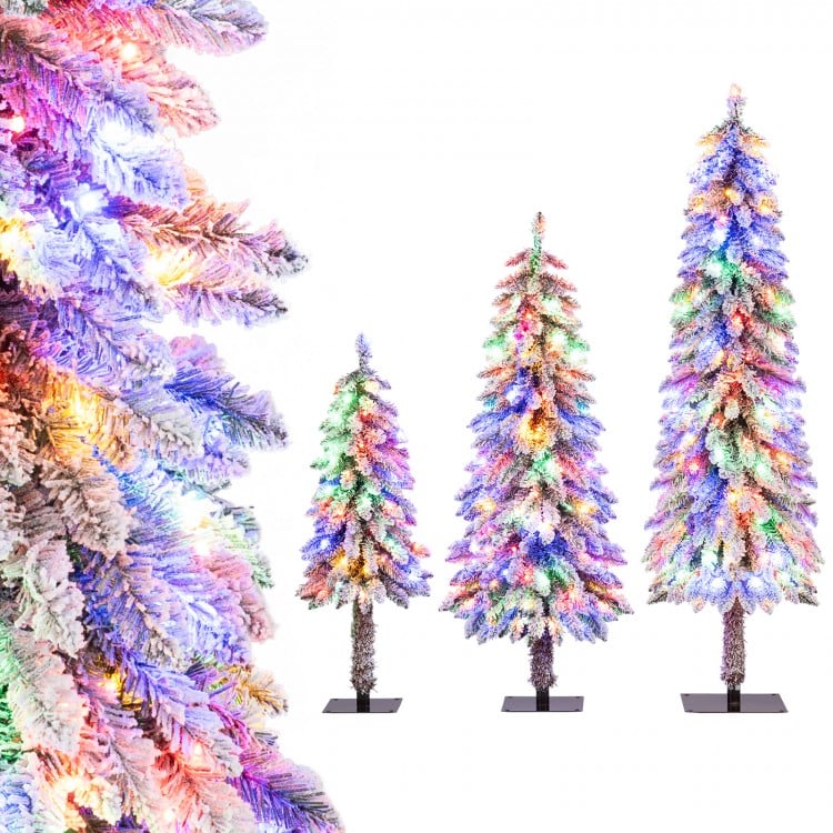Snow-flocked artificial Christmas tree set of 3 with multi-color LED lights for festive indoor decoration.