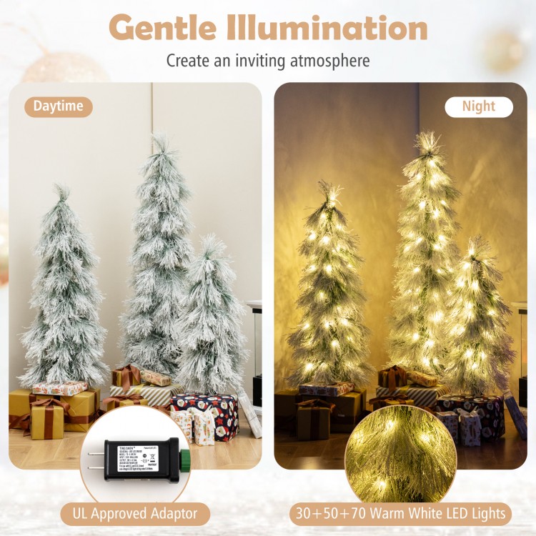 Artificial Christmas tree with snow-flocked tips and warm white LED lights, creating a cozy holiday ambiance at night.