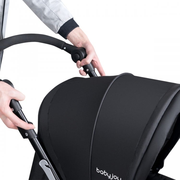 Close-up of the black foldable double baby stroller with adjustable push handle, designed for two babies.