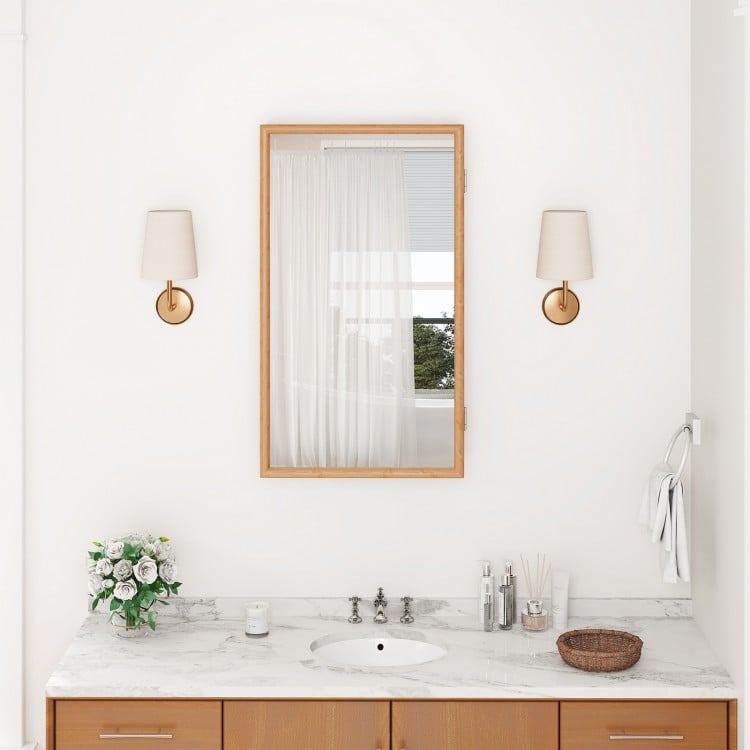 Bamboo small medicine cabinet with mirror door, featuring removable shelves and a varnished surface for easy cleaning.