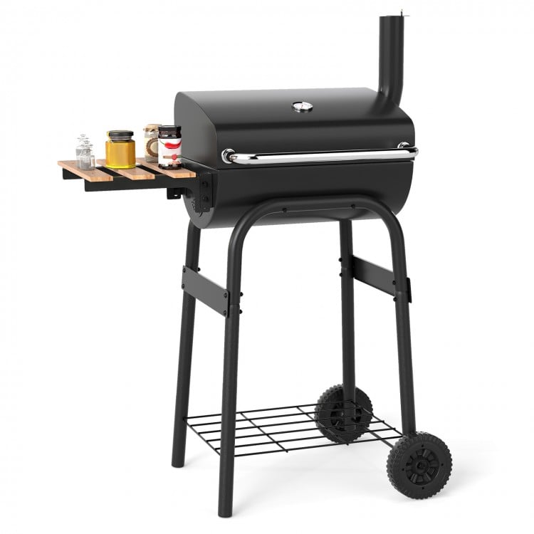 Barrel charcoal grill with foldable side table, built-in thermostat, and adjustable air vents for backyard cooking.