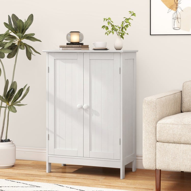 White bathroom floor storage cabinet with double doors and shelves, perfect for organizing toiletries and other essentials.