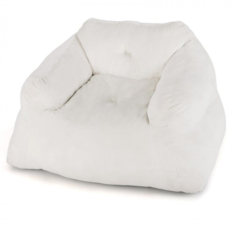 Plush beige bean bag chair with overstuffed backrest and armrests, perfect for relaxing or watching TV.