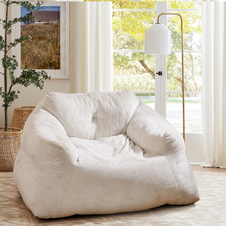 Bean bag chair in beige with ultra-soft velvet cover, featuring ergonomic support for relaxing and lounging.
