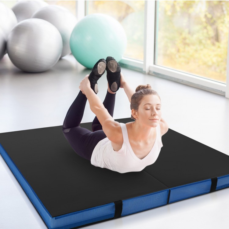 Thick black bi-fold gymnastics mat with carrying handles, ideal for yoga and stretching, featuring a waterproof cover.