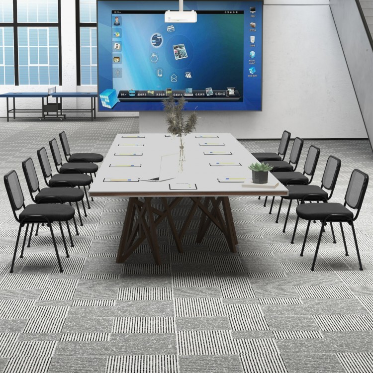 Set of stackable conference chairs with mesh backrest around a large meeting table, ideal for office gatherings.