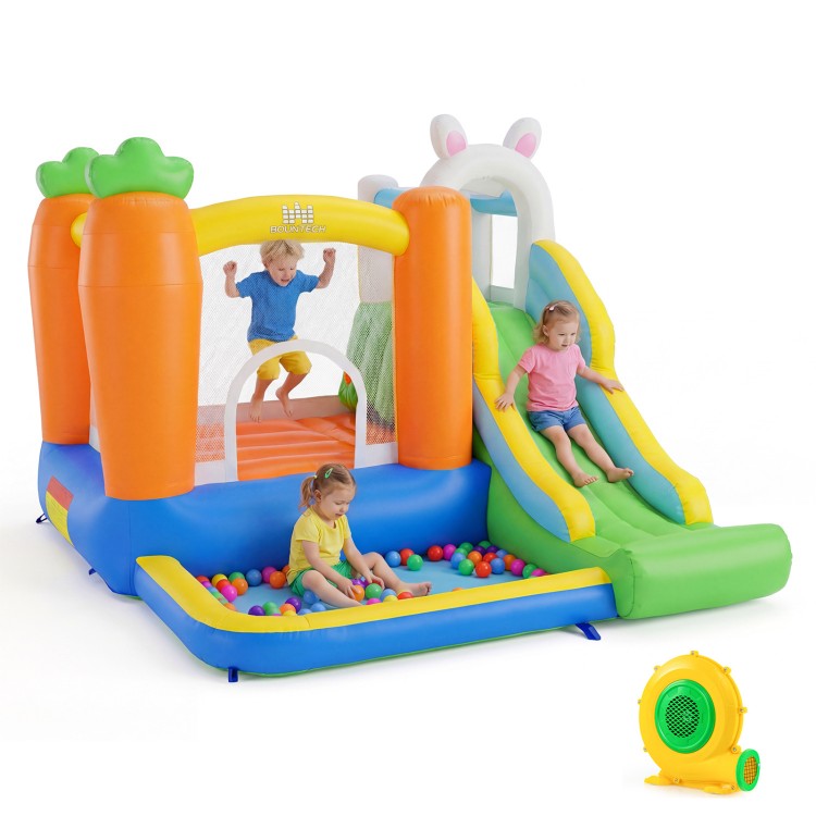 Brightly colored bounce house with climbing wall, slide, and ball pit for kids aged 3-12, perfect for backyard parties.