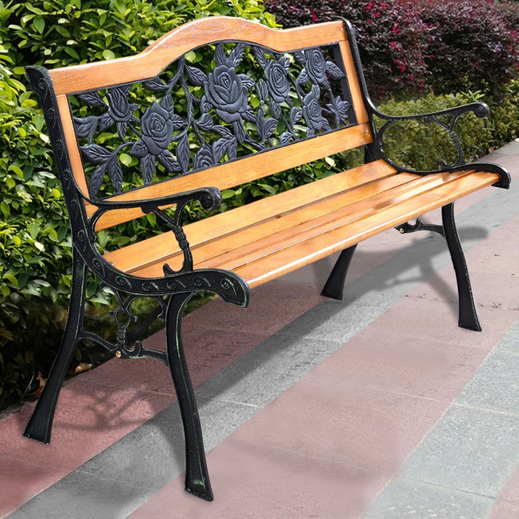 Cast iron outdoor bench with rose pattern backrest and solid wood seat, perfect for patio seating.