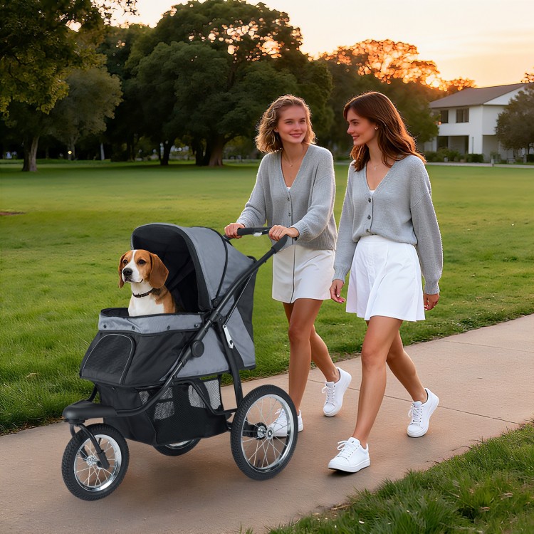 Two women walk a gray 3-wheel pet stroller with a dog, showcasing its foldable design and mesh ventilation.