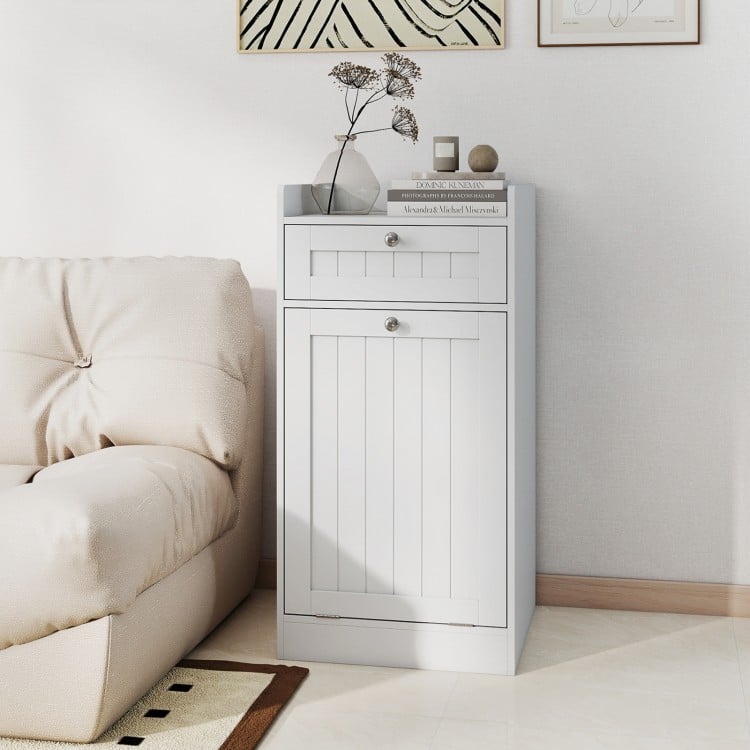 Tilt-out laundry hamper cabinet in white showcasing a deep drawer and raised edges, perfect for bathroom organization.