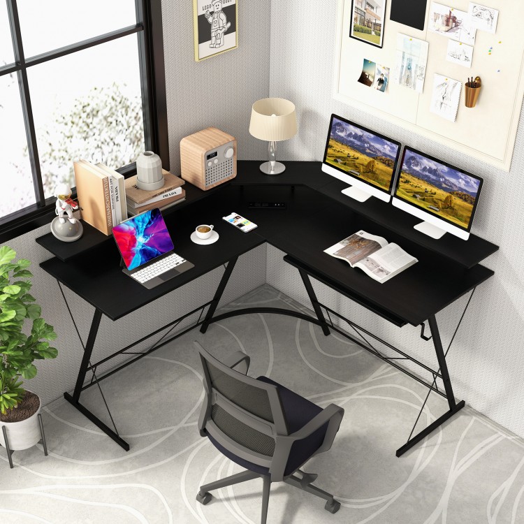 L-shaped black computer desk with monitor stand, power outlet, and adjustable foot pads for a stable workspace.