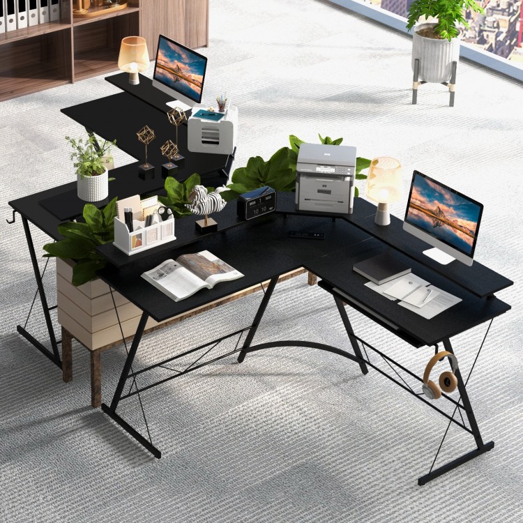 L-shaped black computer desk with monitor stand, power outlet, and keyboard tray, ideal for corner workspace.