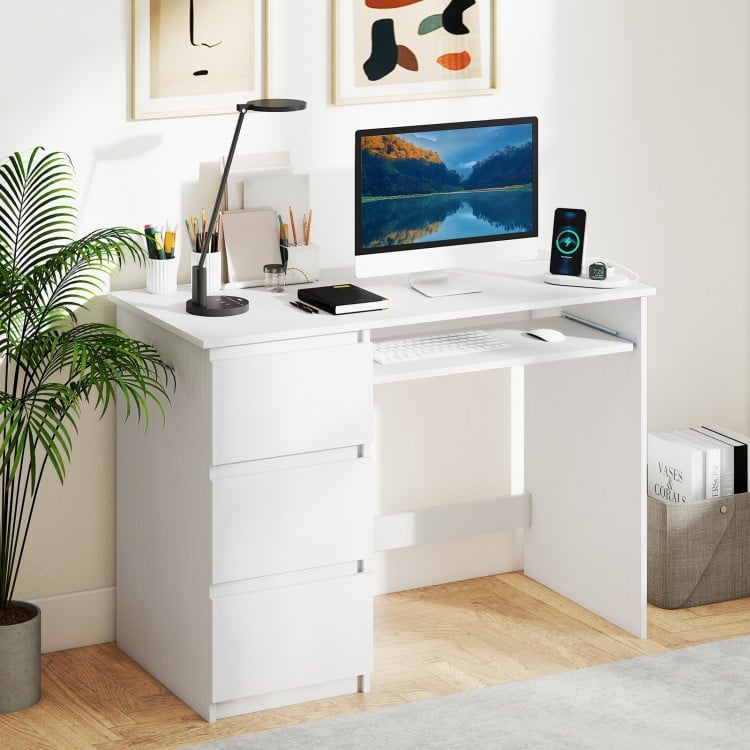 Computer desk in white featuring a keyboard tray, three large drawers, and built-in power outlet for home office use.