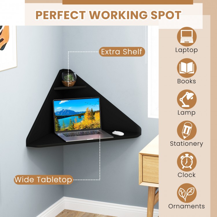 Floating triangular corner computer desk in black with wide tabletop and extra shelf, ideal for compact spaces.