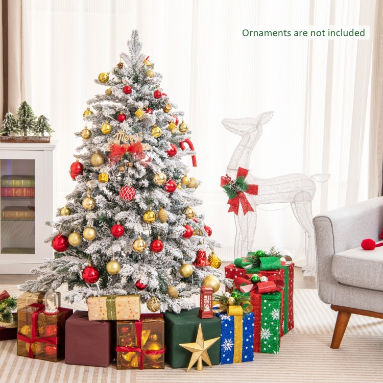 Flocked 4.5 ft Christmas tree with warm white LED lights, surrounded by wrapped gifts, perfect for festive decor.