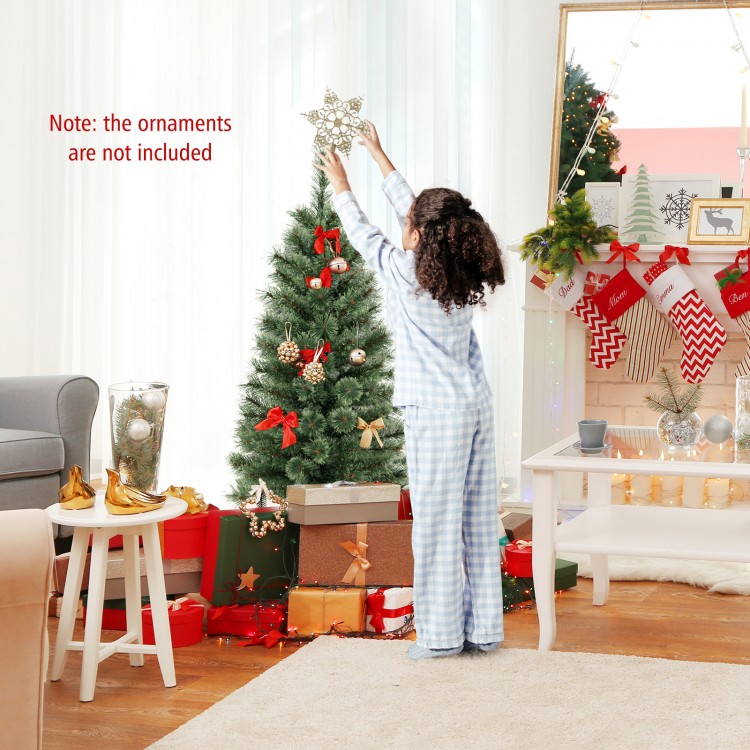 Child placing a star on a 4-foot pre-lit potted Christmas tree with flowering pine needles for festive decor.