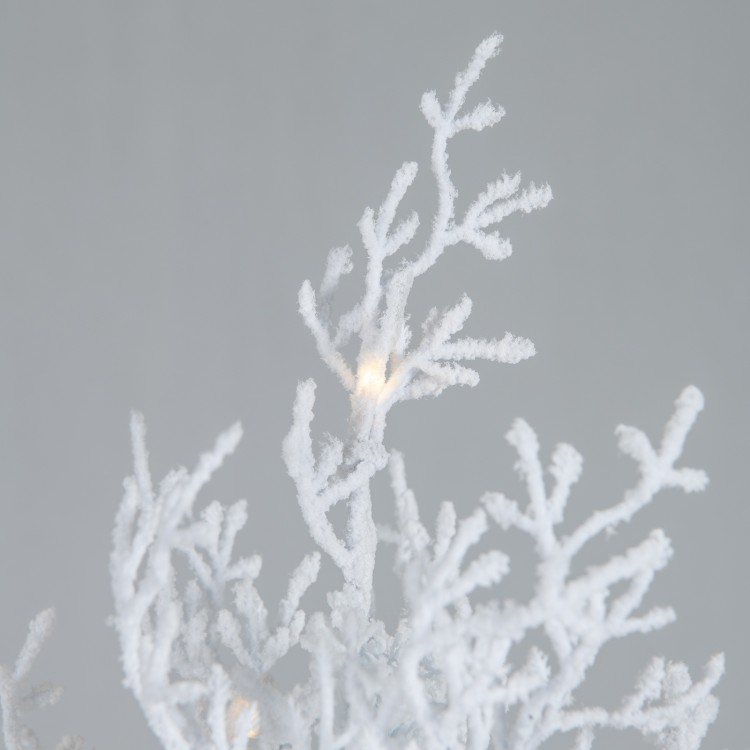 Flocked branches of a 6-foot artificial Xmas tree with 300 LED lights, ideal for festive home decoration.