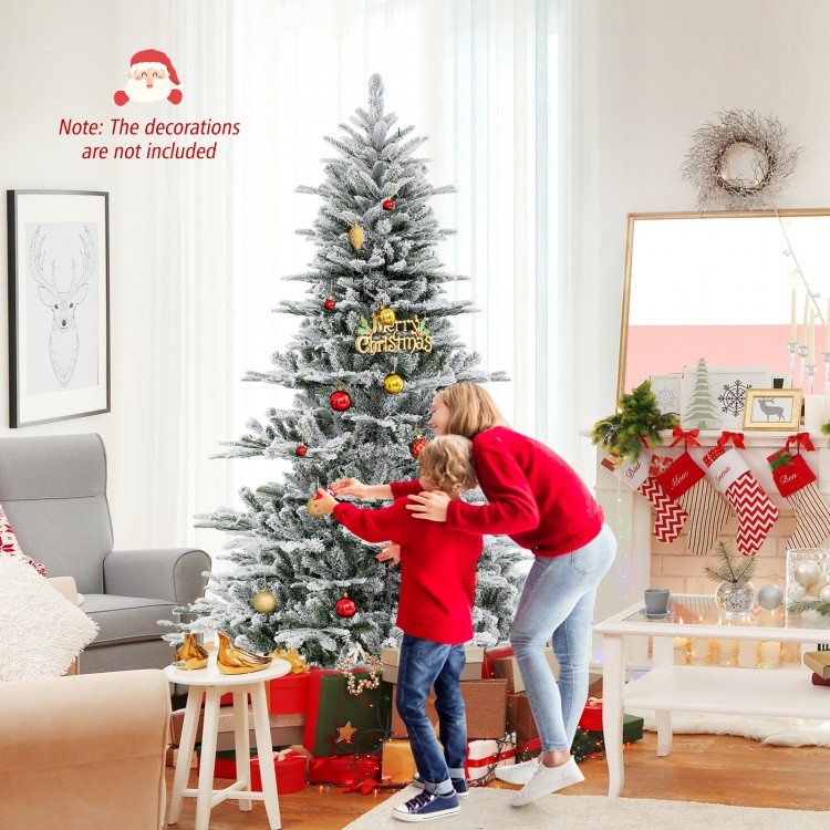 Snow flocked 7 feet artificial Christmas tree with cool white LED lights, perfect for festive home decoration.