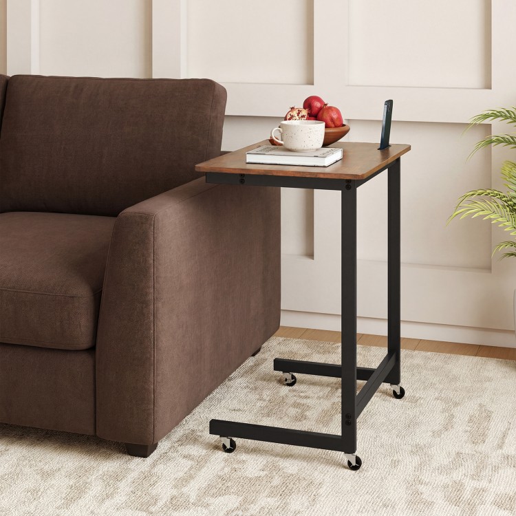 C-shaped end table in rustic brown with wheels, phone slot, and spacious top for snacks, fitting snugly beside a couch.