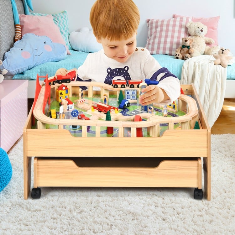 Kids wooden train set table with 100 colorful pieces, featuring lockable wheels and a storage drawer for easy play.