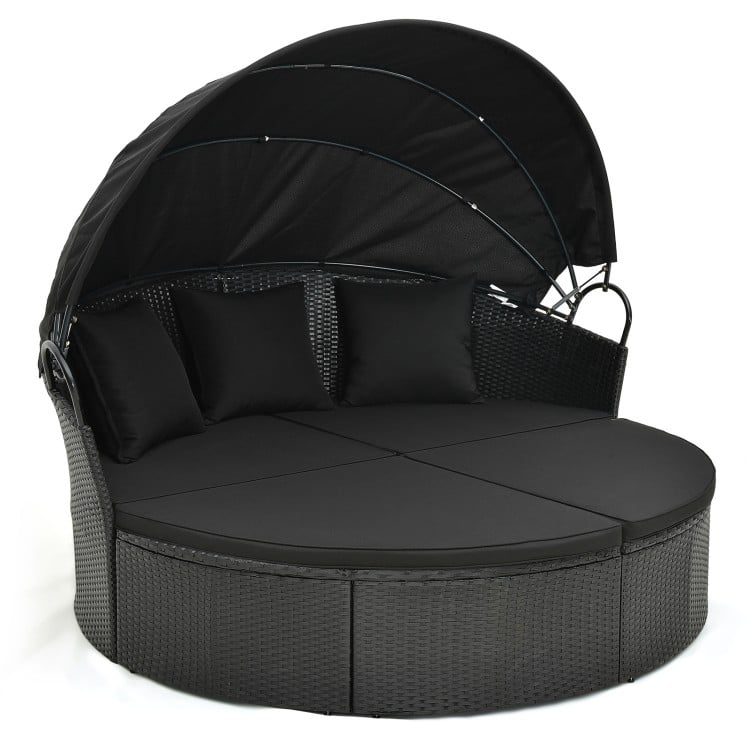 Round Clamshell Patio Daybed in black wicker with retractable canopy and plush cushions, perfect for outdoor relaxation.
