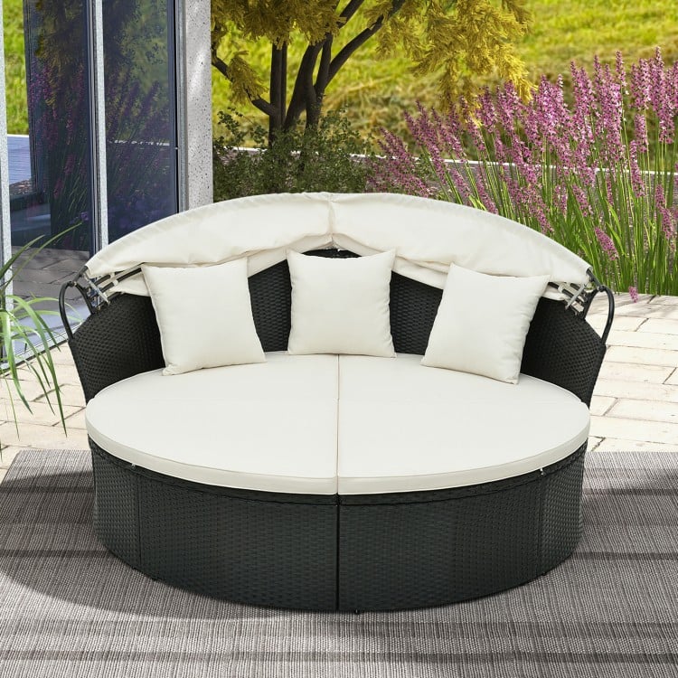 Round patio daybed with retractable canopy, off-white cushions, and premium PE rattan for outdoor relaxation.
