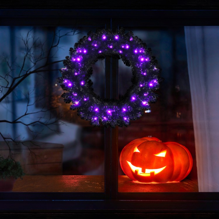 24-inch pre-lit Halloween wreath with 35 purple LED lights, enhancing spooky decor for festive celebrations.