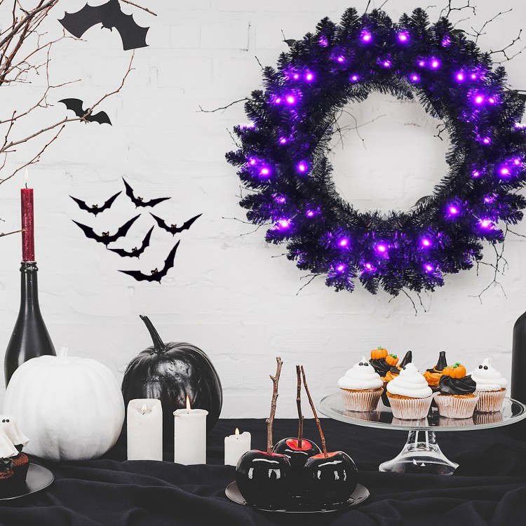 24-inch pre-lit Halloween wreath with 35 purple LED lights, featuring lifelike branch tips for a spooky festive.