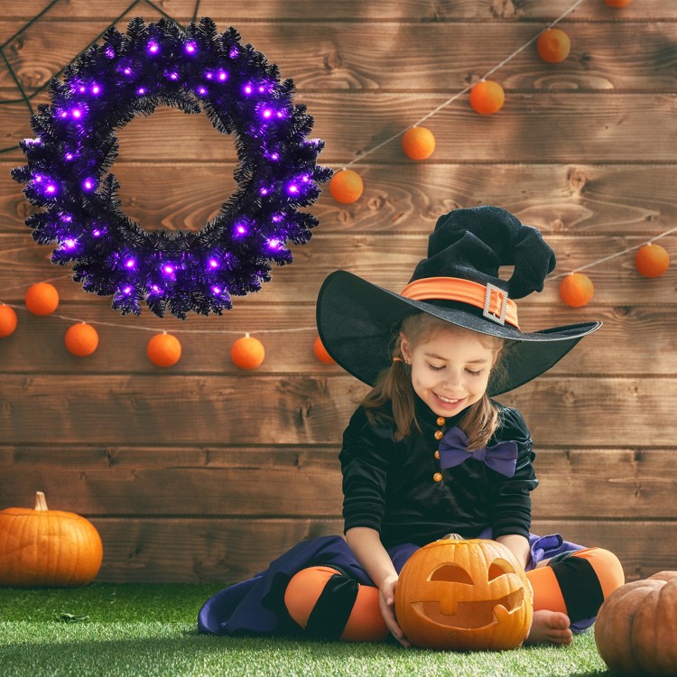 24-inch pre-lit Halloween wreath with 35 purple LED lights, enhancing festive spirit in a spooky outdoor setting.